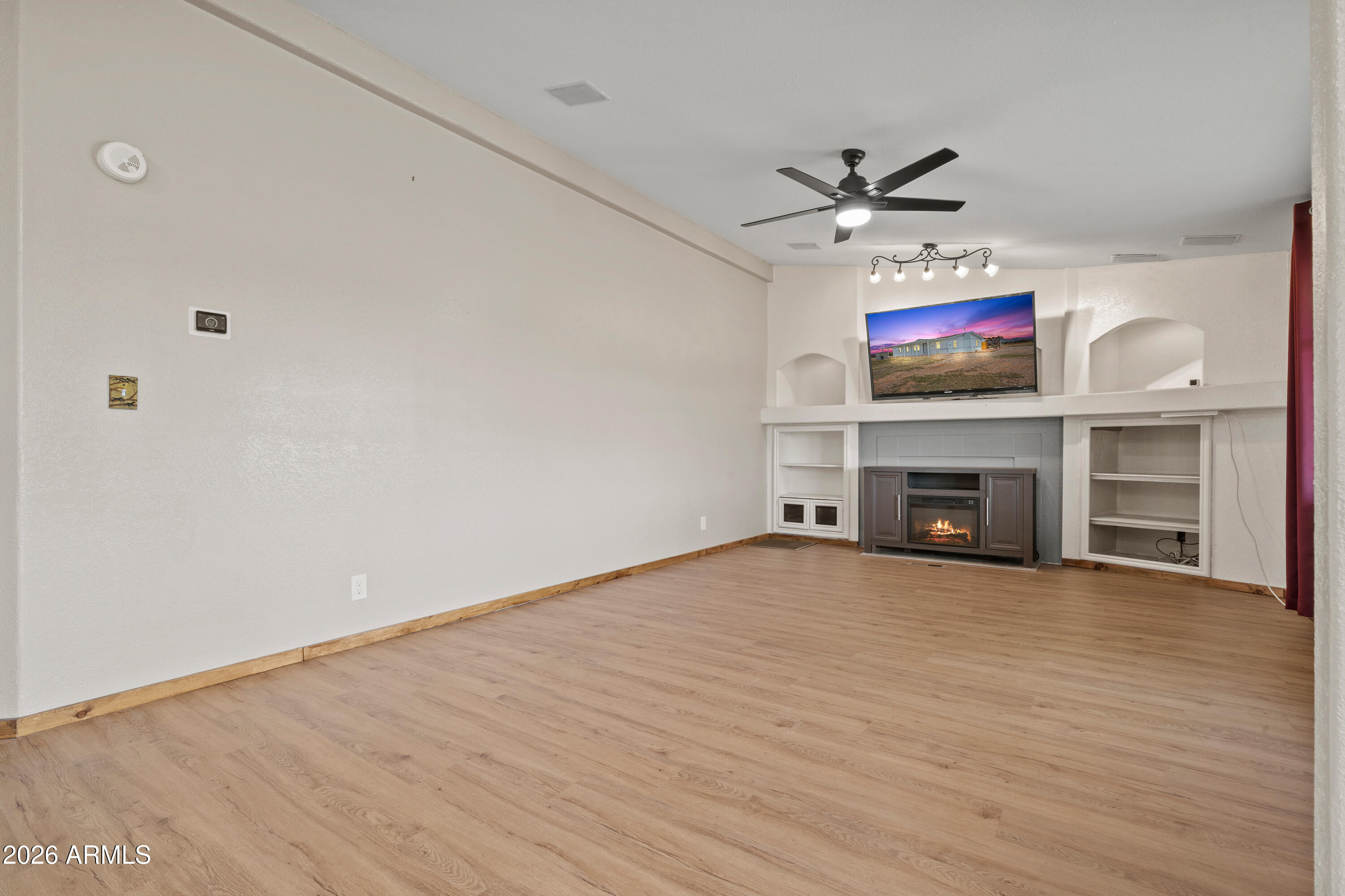 10072 South Shiloh Ranch Road Hereford, AZ 85615 - Photo 7 of 46 a view of an empty room with a fireplace