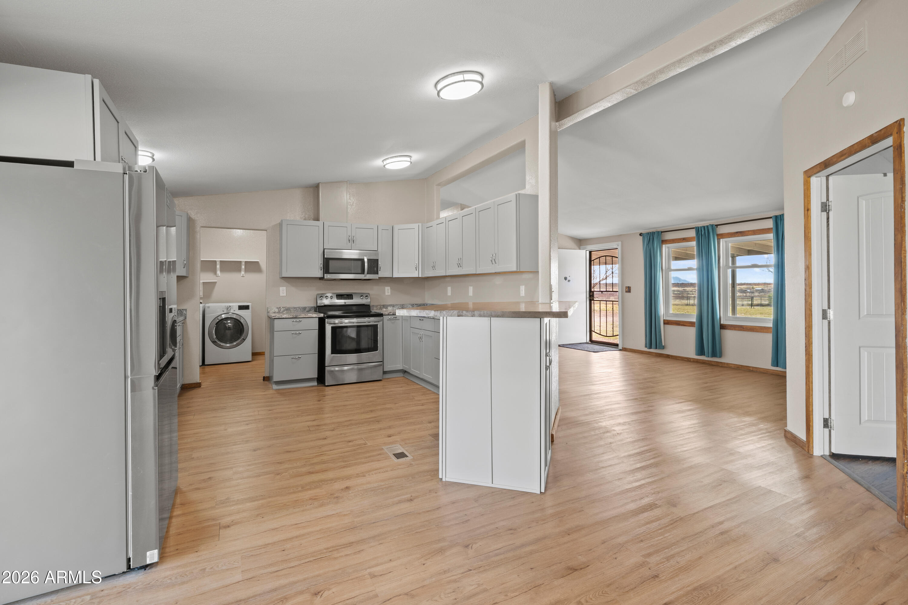 10072 South Shiloh Ranch Road Hereford, AZ 85615 - Photo 8 of 46 a kitchen with stainless steel appliances granite countertop a refrigerator oven a stove top oven and a refrigerator with wooden floor