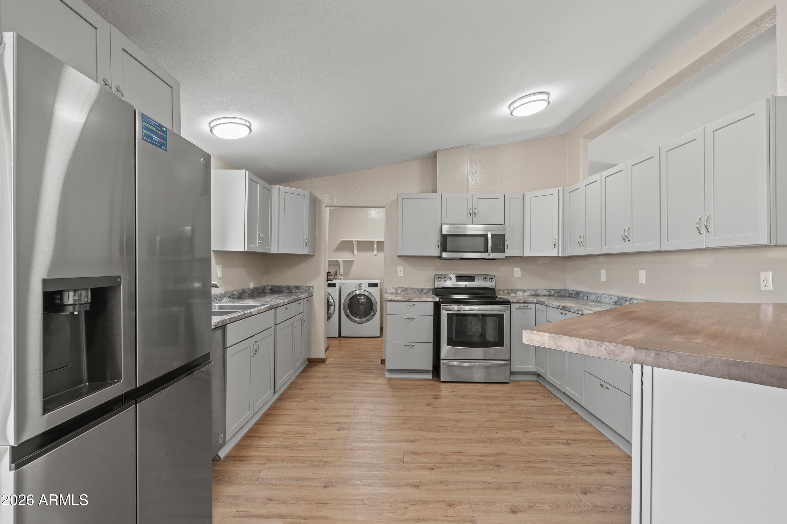 10072 South Shiloh Ranch Road Hereford, AZ 85615 - Photo 9 of 46 a large kitchen with stainless steel appliances granite countertop a stove a refrigerator and a sink
