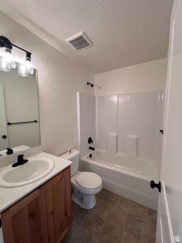 1696 South Longview Road Santaquin, UT 84655 - Photo 11 of 16 Full bath with vanity, a textured ceiling, and shower / bathtub combination