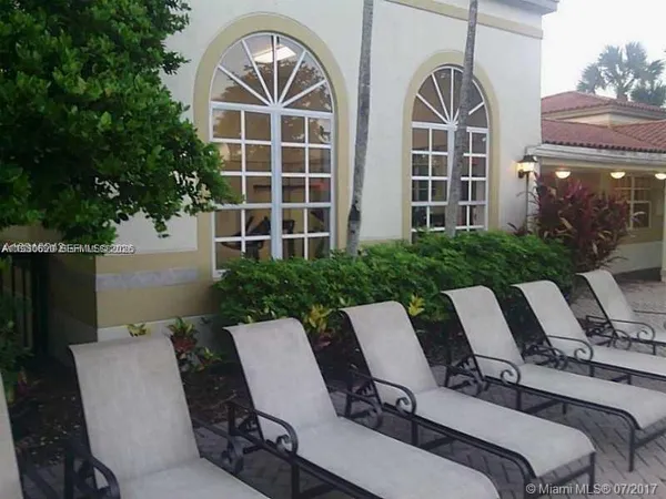 a view of a patio with table and chairs and potted plants