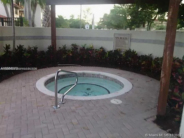 a small pool with some trees in the background