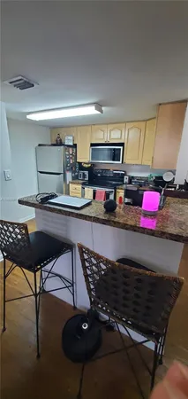 a kitchen with a stove a microwave and cabinets