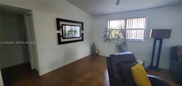 a view of entryway with window and wooden floor