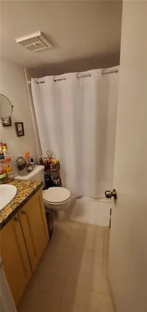 a bathroom with a sink mirror vanity and toilet
