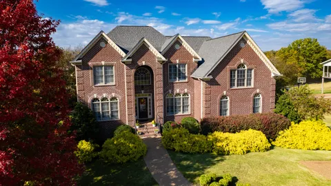 a front view of a house with a yard and outdoor seating