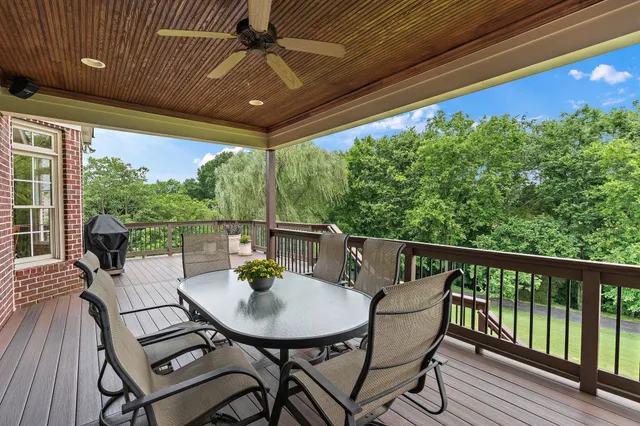 a view of a balcony with furniture and wooden floor