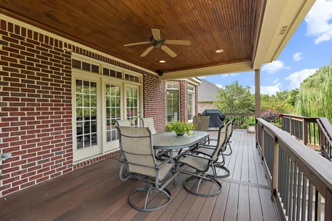 a view of a porch with furniture and wooden floor