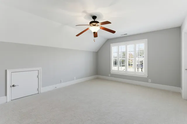 a view of room with a ceiling fan and window