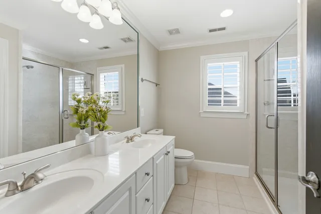 a bathroom with a granite countertop sink a mirror and a bathtub