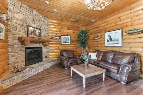 a living room with furniture a fireplace and a wooden floor