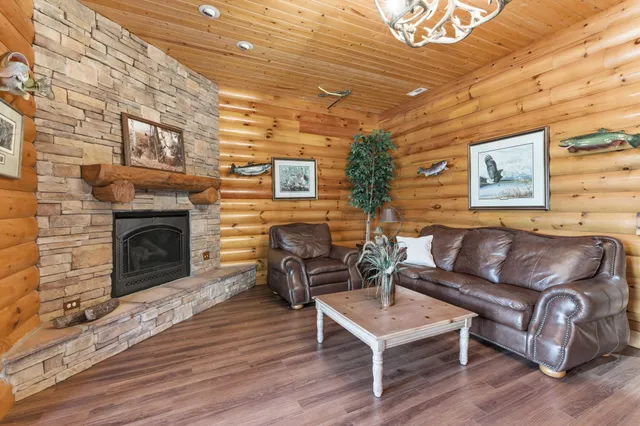 a living room with furniture a fireplace and a wooden floor