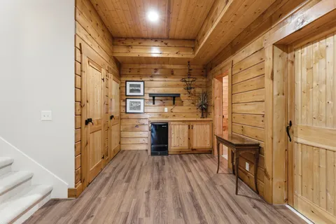 a kitchen with cabinets and wooden floor