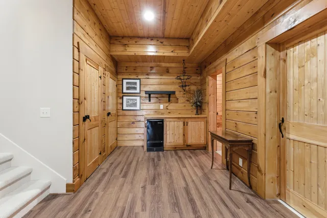 a kitchen with cabinets and wooden floor