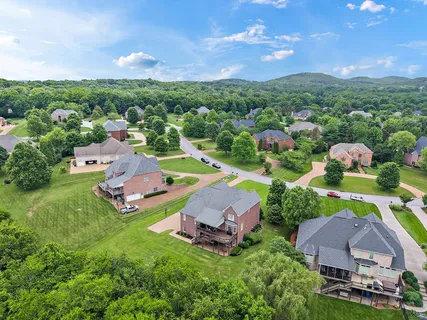 a view of multiple houses with outdoor space and a lake view