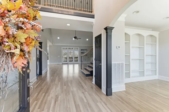 a view of a hallway view with wooden floor and staircase