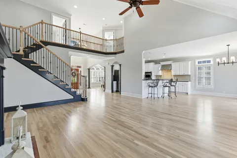 a view of dining room with wooden floor and stairs