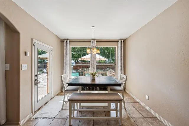 a dining room with a table and chairs