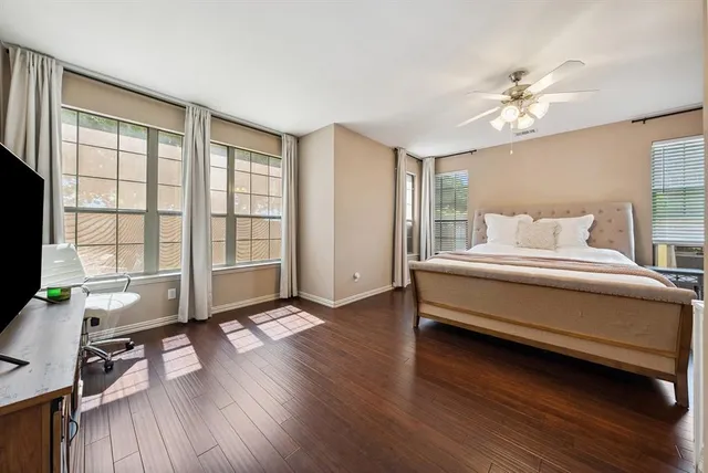 a bedroom with a bed furniture and a large window
