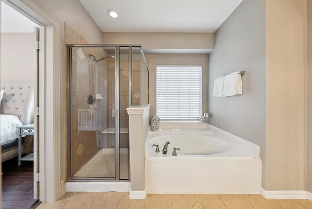 a bathroom with a bathtub and a shower