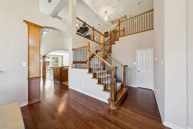 a view of entryway with wooden floor and stairs