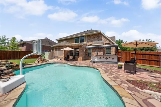 a front view of house with yard and outdoor seating