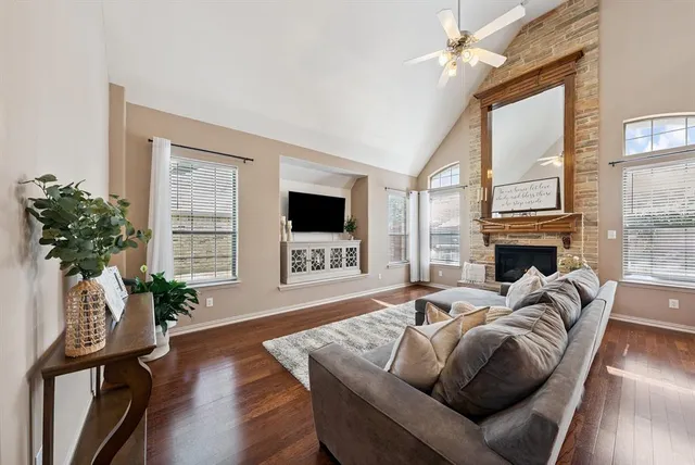 a living room with furniture fireplace and window