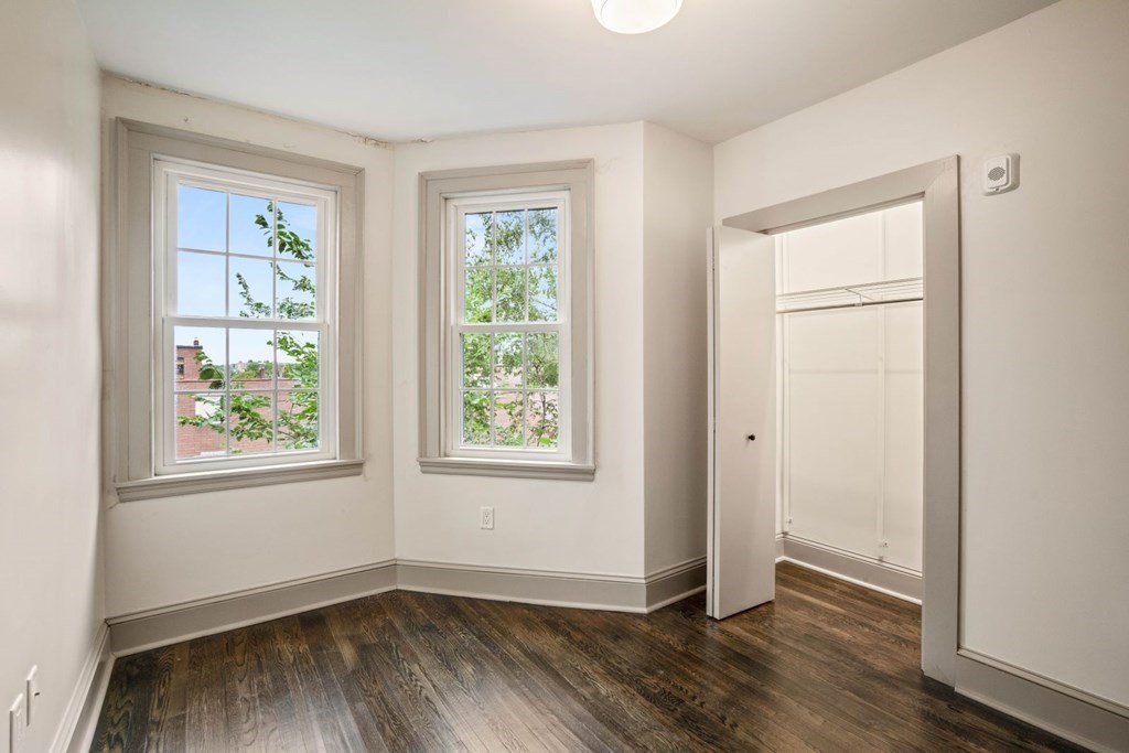 9 Dana Street, Unit 33 Cambridge, MA 02138 - Photo 13 of 15 an empty room with wooden floor and windows
