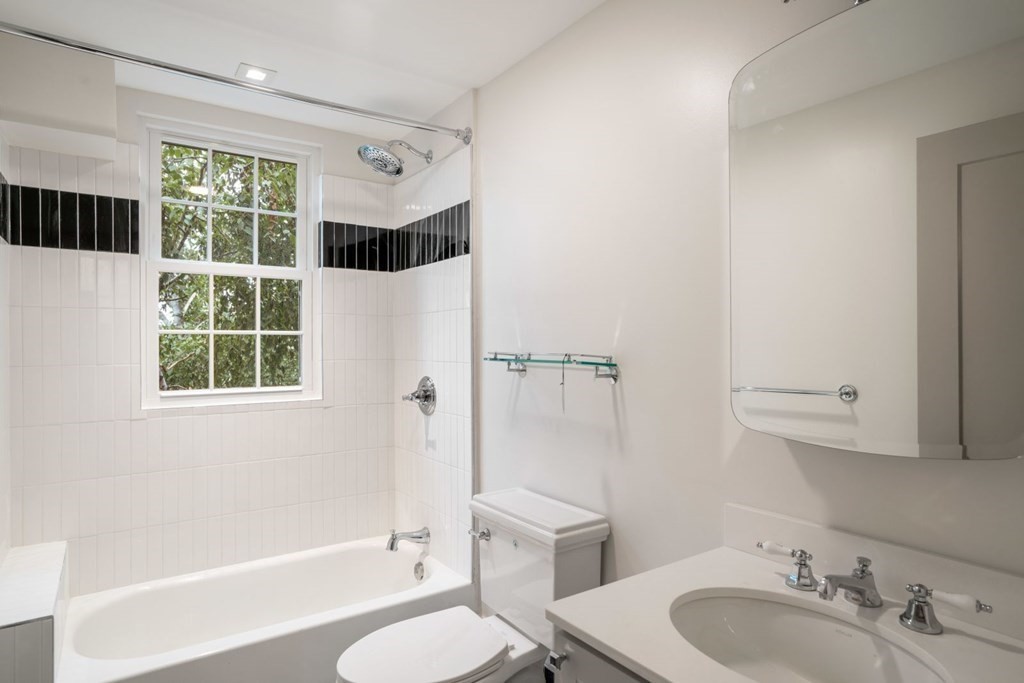 9 Dana Street, Unit 33 Cambridge, MA 02138 - Photo 14 of 15 a bathroom with a sink toilet a mirror and shower