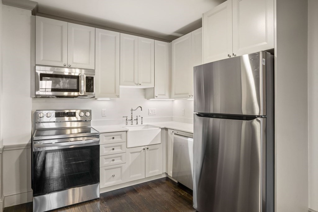 9 Dana Street, Unit 33 Cambridge, MA 02138 - Photo 2 of 15 a kitchen with appliances a refrigerator and cabinets
