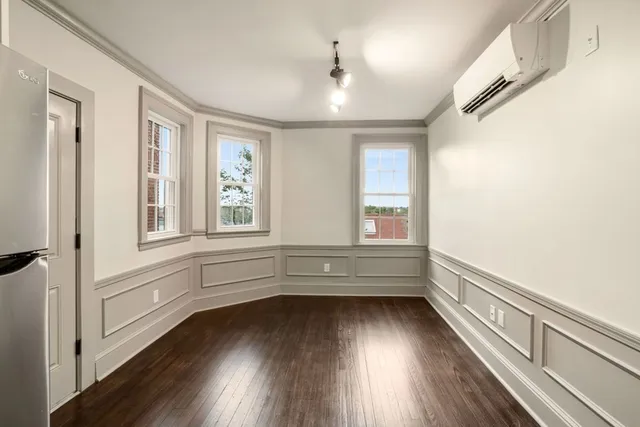 a view of lot with window and wooden floor