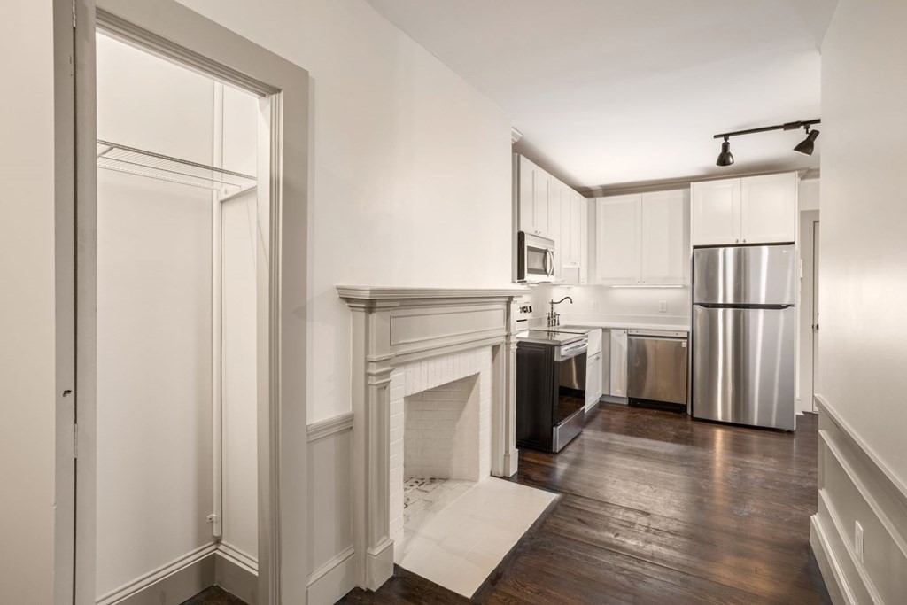 9 Dana Street, Unit 33 Cambridge, MA 02138 - Photo 7 of 15 a kitchen with white cabinets and white appliances
