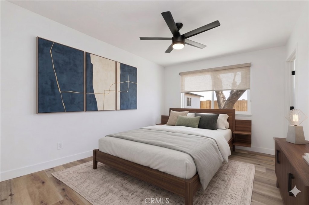 6940 Keating Drive Riverside, CA 92503 - Photo 8 of 15 a bedroom with a large bed and a window