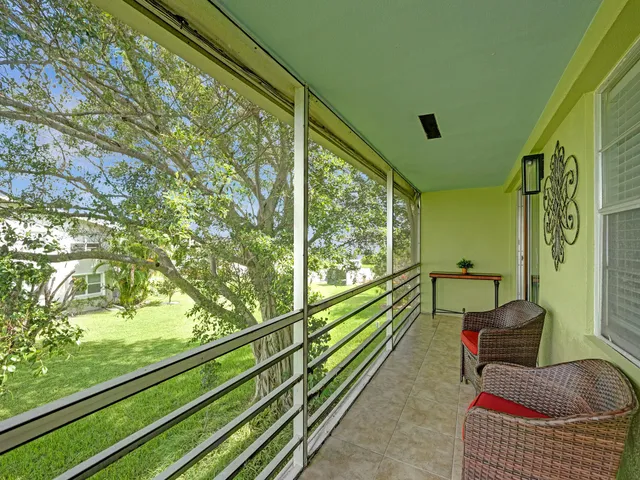 a balcony with chairs and a table