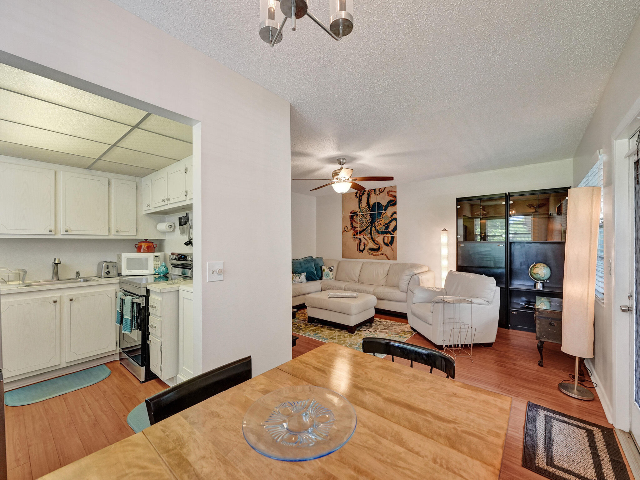 232 Farnham J, Unit 232 Deerfield Beach, FL 33442 - Photo 14 of 38 a living room with furniture and a kitchen view