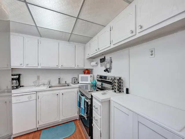 a kitchen with cabinets appliances a sink and cabinets