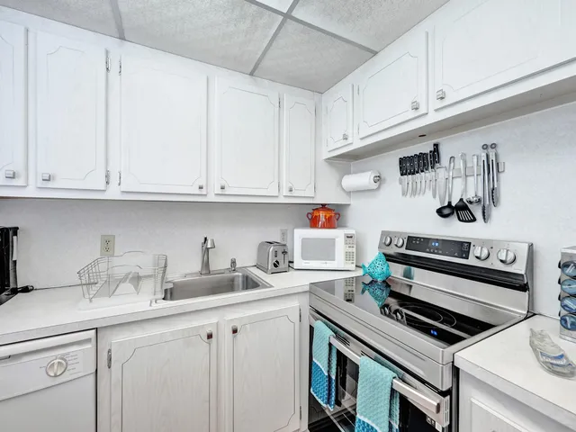 a kitchen with stainless steel appliances granite countertop a sink and cabinets
