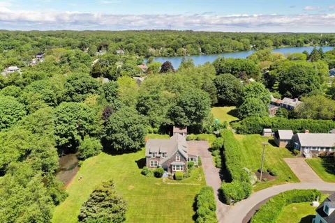 an aerial view of a house with garden space and street view