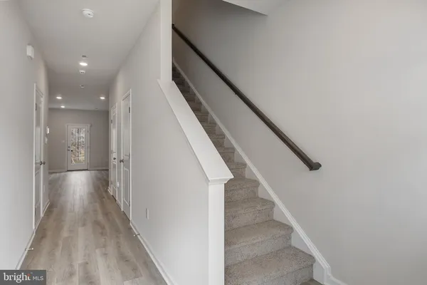 a view of entryway and hall with wooden floor