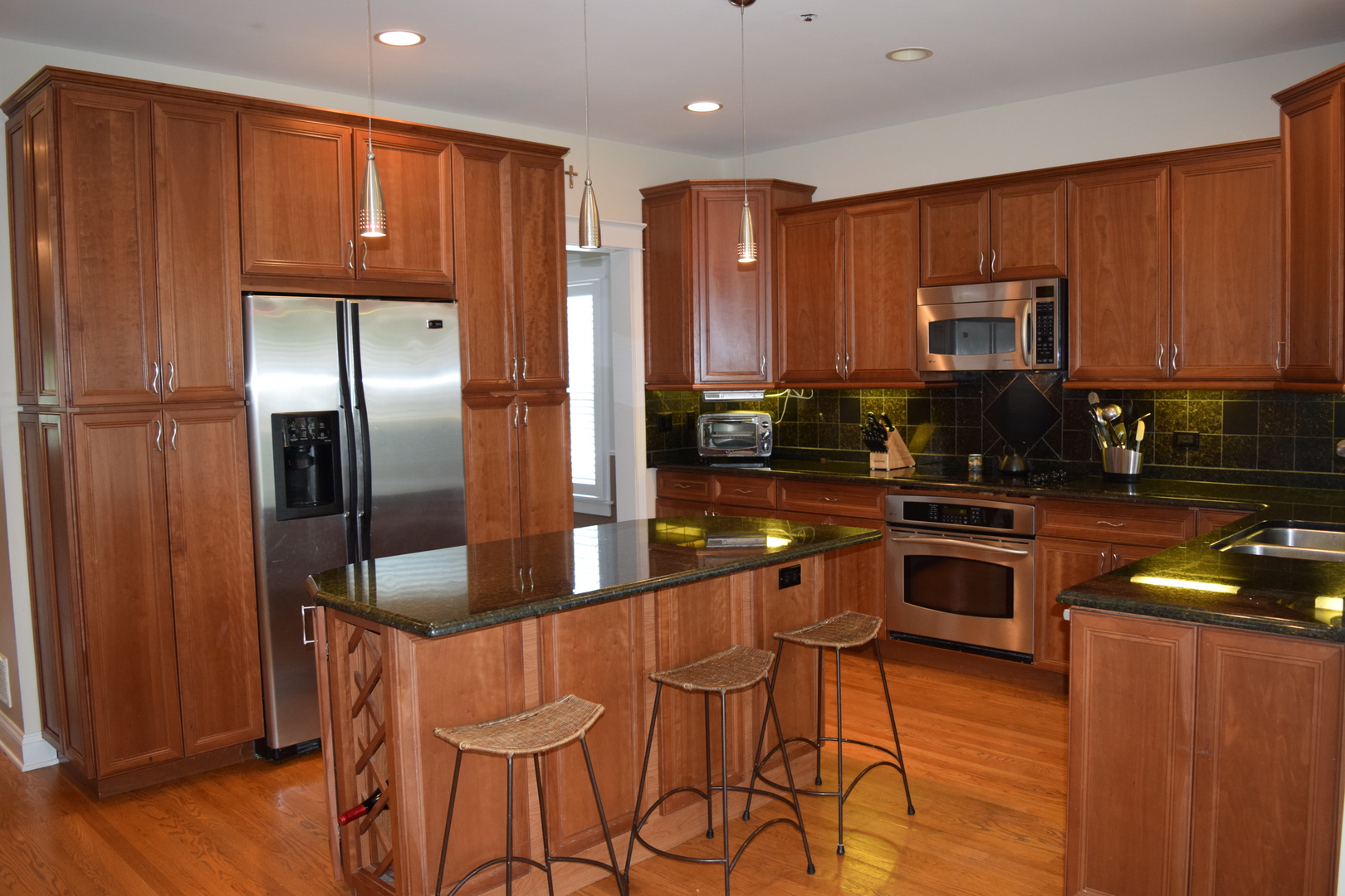 707 North Delphia Avenue Park Ridge, IL 60068 - Photo 2 of 22 a kitchen with stainless steel appliances granite countertop a refrigerator a stove top oven and a sink with wooden floor