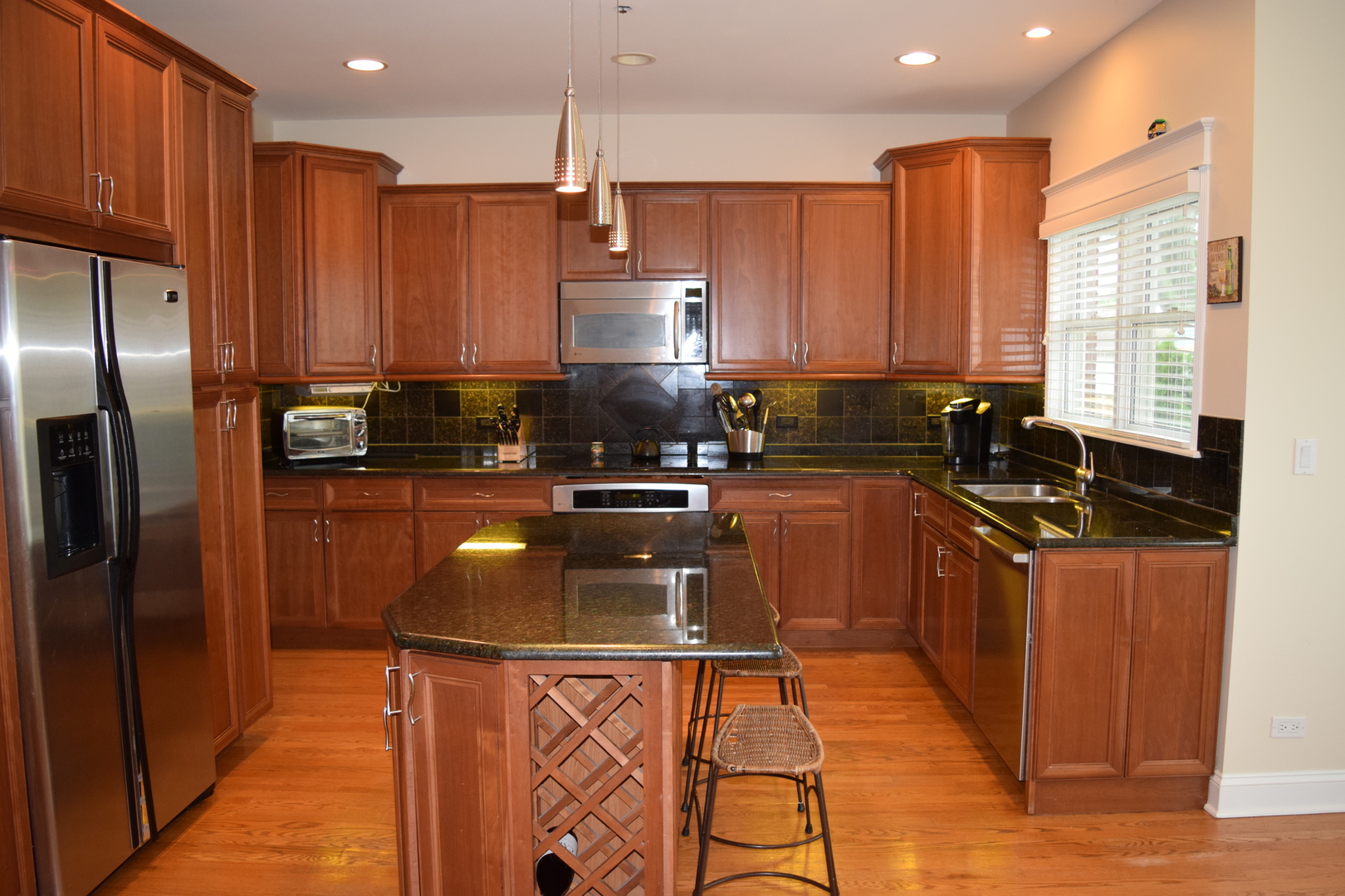 707 North Delphia Avenue Park Ridge, IL 60068 - Photo 3 of 22 a kitchen with stainless steel appliances granite countertop a sink a stove and a refrigerator