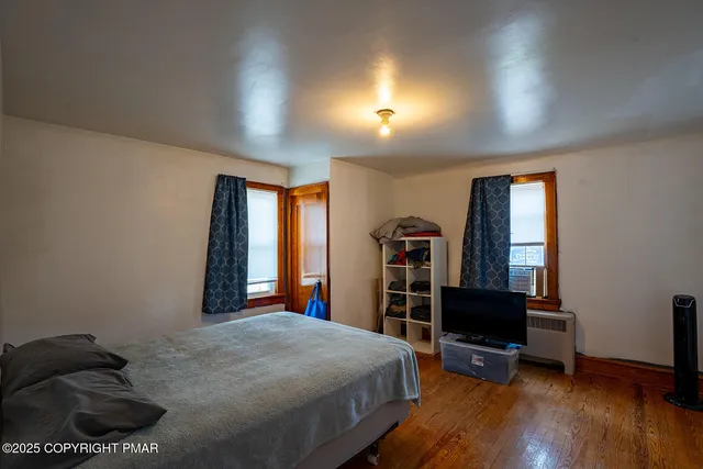 a bedroom with a bed and a chair