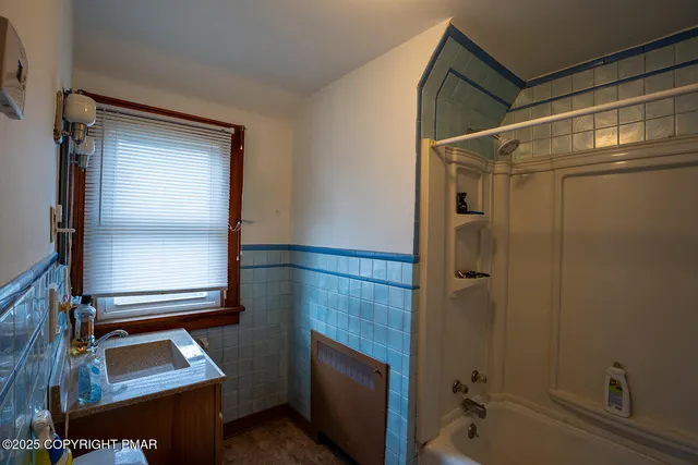 a bathroom with a bathtub and shower