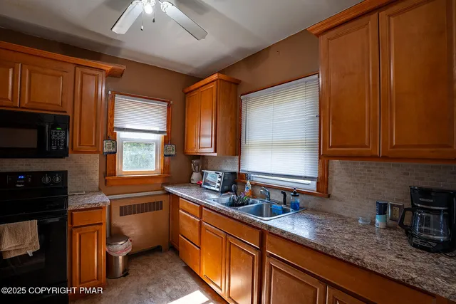 a kitchen with stainless steel appliances granite countertop wooden cabinets a stove top oven a sink and dishwasher
