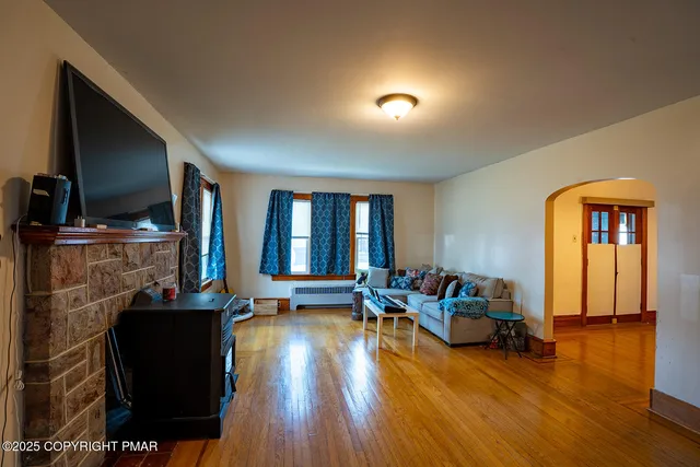 a living room with furniture and a flat screen tv