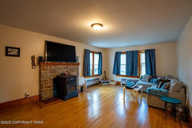 a living room with fireplace furniture and a flat screen tv