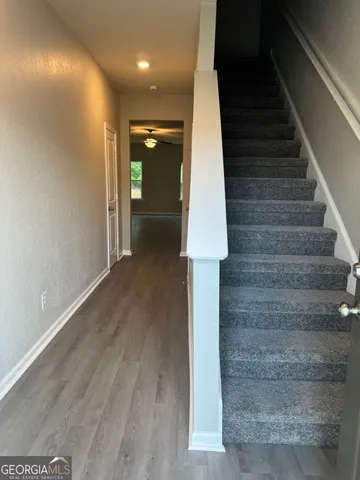 a view of entryway and hall with wooden floor