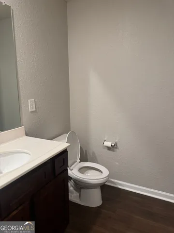 a white toilet sitting next to a bathroom sink