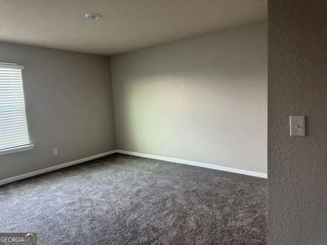 an empty room with a empty space and window