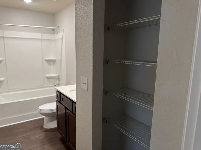 a bathroom with a shower a toilet and sink